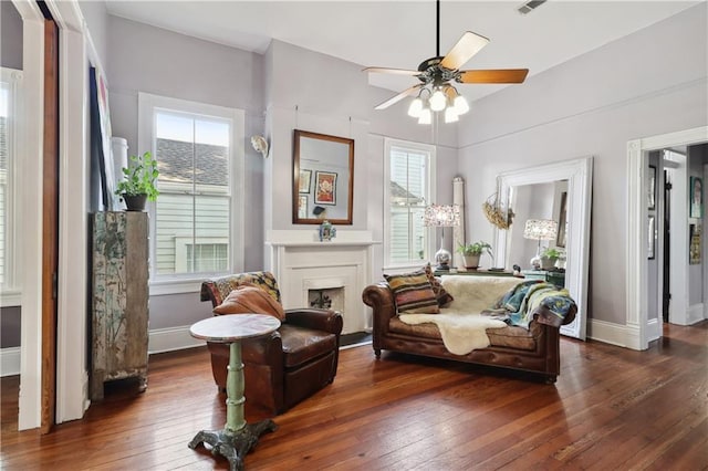 interior space with ceiling fan, dark wood-type flooring, and a wealth of natural light