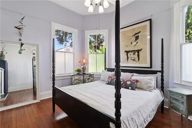 bedroom with ceiling fan and dark wood-type flooring