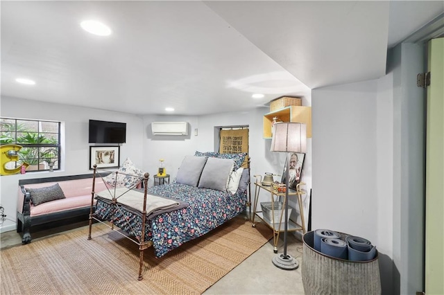 bedroom featuring an AC wall unit and concrete floors