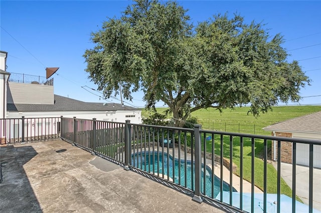 balcony featuring a patio and a fenced in pool