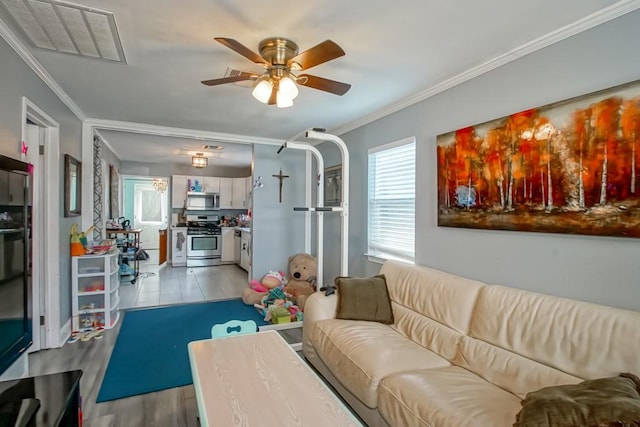 tiled living room featuring ornamental molding and ceiling fan