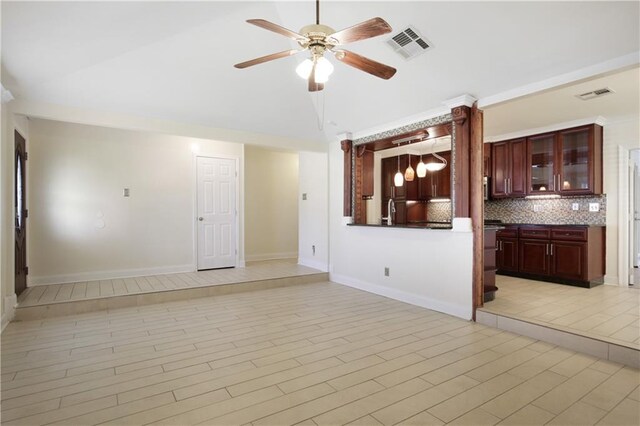 unfurnished living room featuring ceiling fan, light tile patterned floors, and sink