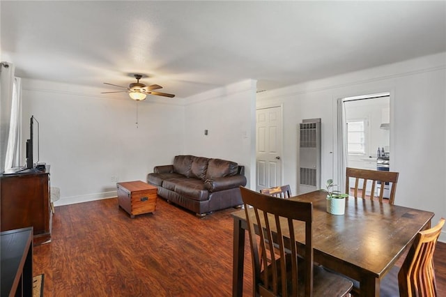 dining area featuring ceiling fan, baseboards, and dark wood-style flooring