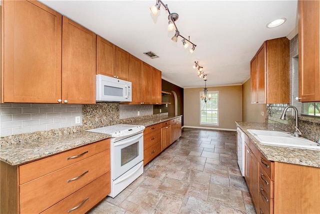 kitchen with white appliances, decorative backsplash, sink, light tile patterned flooring, and rail lighting