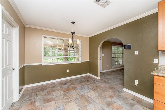 unfurnished dining area with light tile patterned floors, a chandelier, and ornamental molding