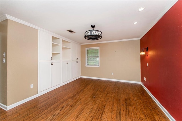 unfurnished room with dark hardwood / wood-style flooring and crown molding