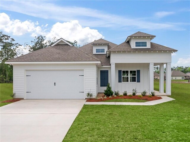 view of front of property with a garage and a front yard