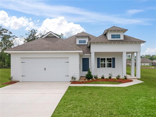 view of front of home featuring a garage and a front yard