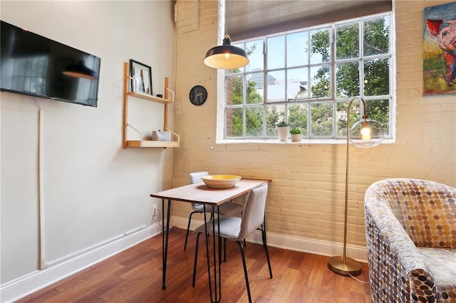 dining space with wood-type flooring