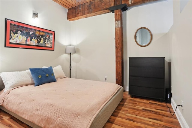 bedroom with wood ceiling, hardwood / wood-style flooring, and beam ceiling