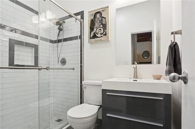 bathroom featuring walk in shower, vanity, and toilet