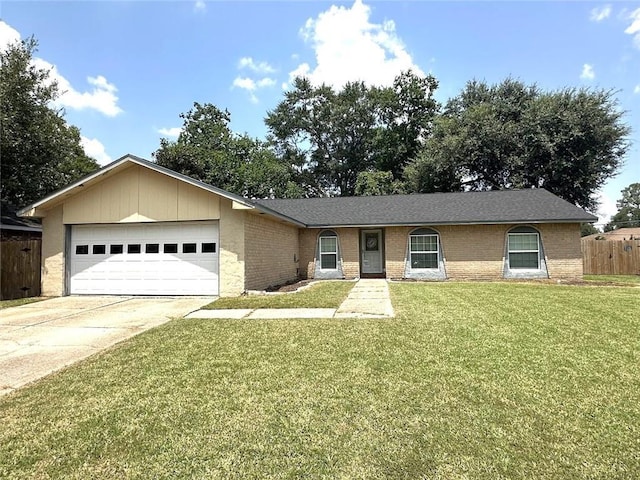 ranch-style house featuring an attached garage, driveway, brick siding, and a front yard