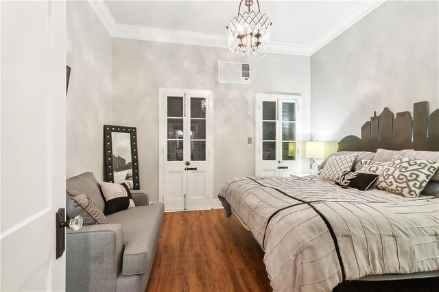 719 St Ann St Unit 2, New Orleans, LA 70116 - bedroom with ornamental molding, a chandelier, and wood finished floors
