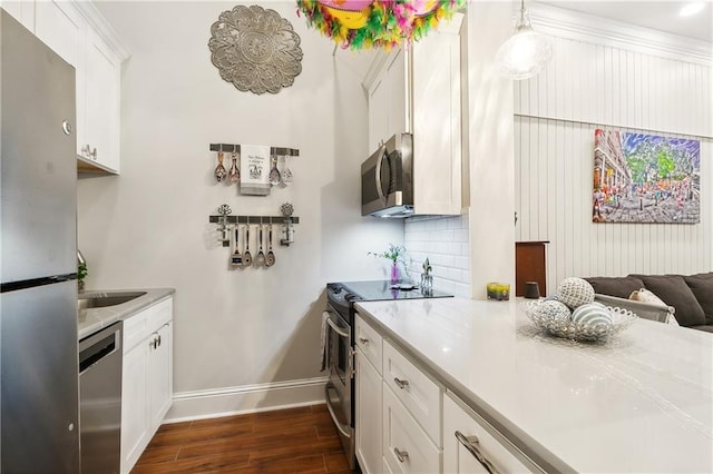 719 St Ann St Unit 2, New Orleans, LA 70116 - kitchen featuring stainless steel appliances, dark wood-style floors, baseboards, and light countertops