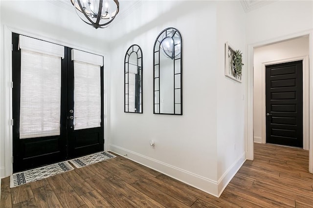 entryway with a notable chandelier, wood-type flooring, and french doors