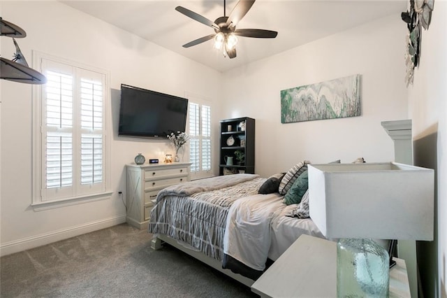 bedroom featuring carpet flooring, ceiling fan, and multiple windows