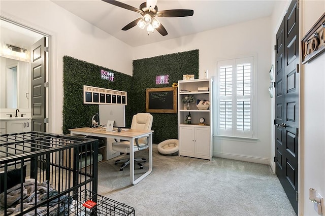 office area featuring light carpet and ceiling fan