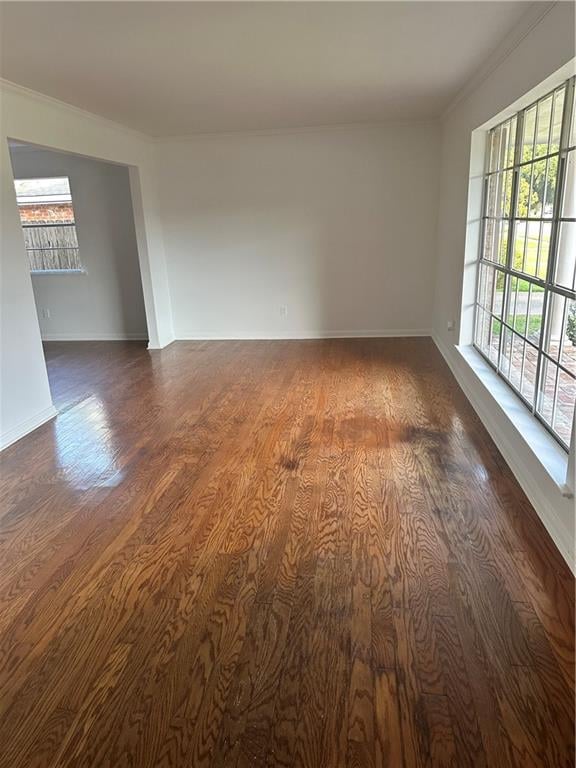 unfurnished room with dark hardwood / wood-style flooring and crown molding