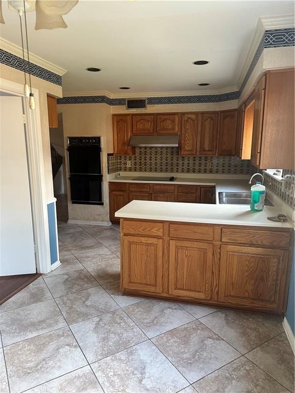 kitchen with crown molding, black appliances, light tile patterned floors, tasteful backsplash, and sink