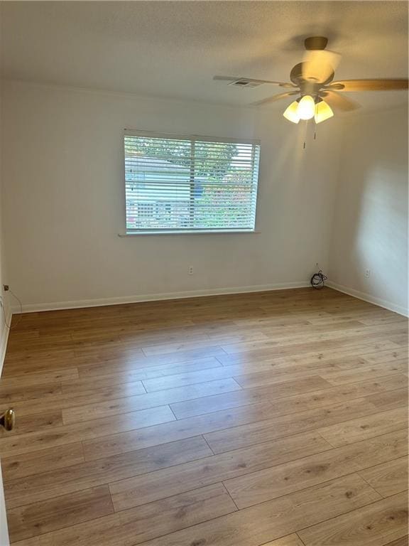 unfurnished room featuring light hardwood / wood-style flooring, ceiling fan, and a wealth of natural light