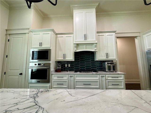 kitchen with ornamental molding, backsplash, light stone countertops, and stainless steel appliances