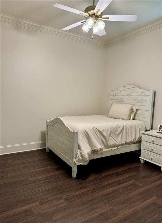 bedroom featuring ceiling fan, crown molding, and dark wood-type flooring