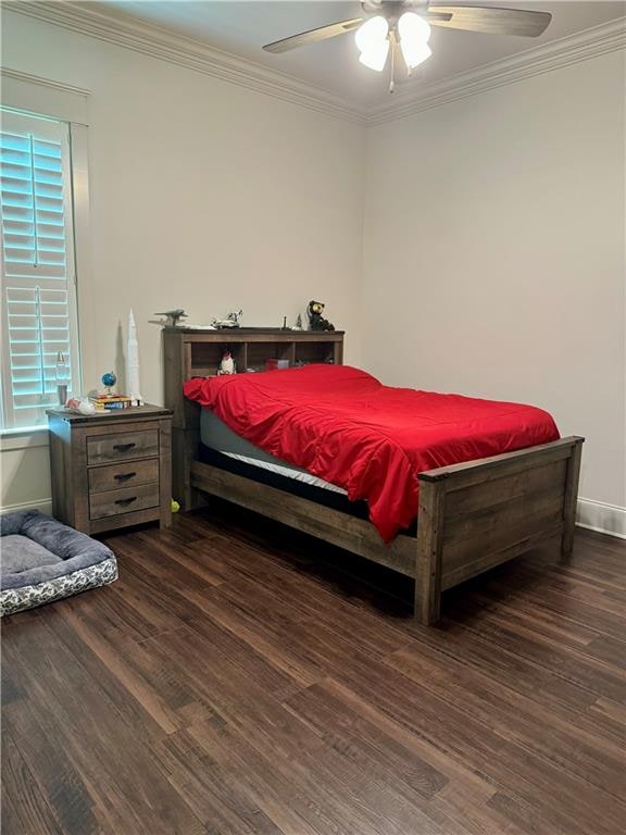 bedroom featuring ceiling fan, crown molding, dark hardwood / wood-style floors, and multiple windows