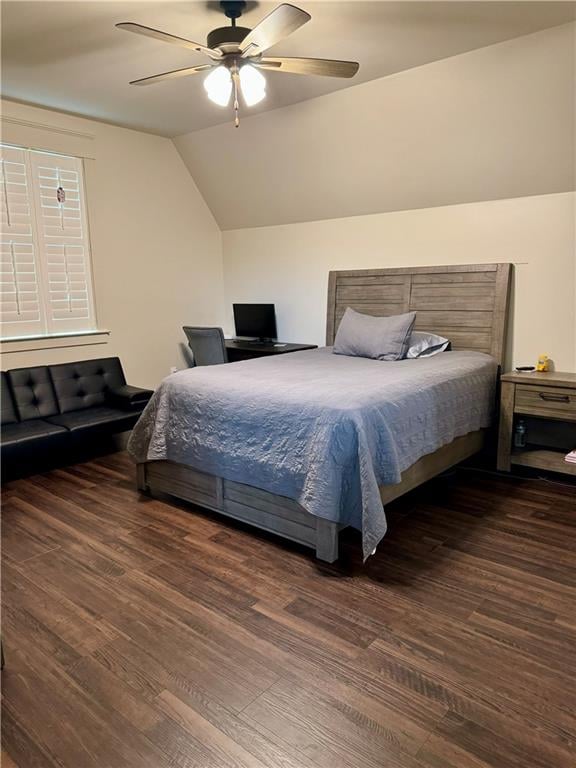 bedroom with ceiling fan, vaulted ceiling, and wood-type flooring