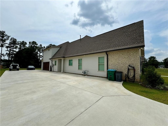 rear view of house featuring a garage