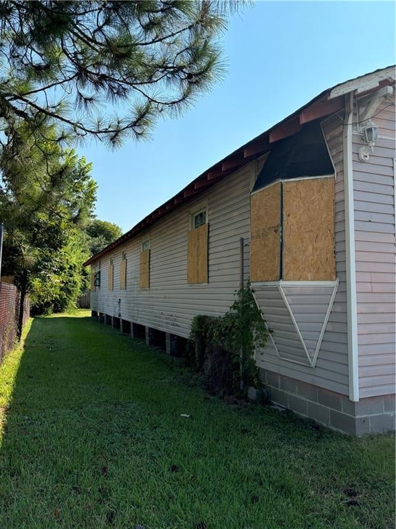 view of side of property with a yard