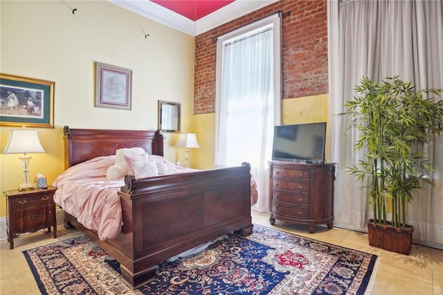 tiled bedroom with crown molding and brick wall