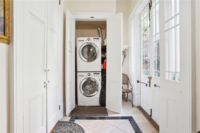 washroom with light tile patterned floors and stacked washer / dryer