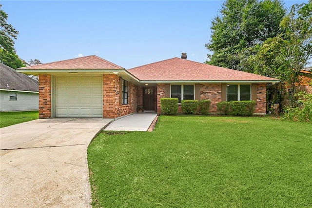 ranch-style house featuring a garage and a front yard