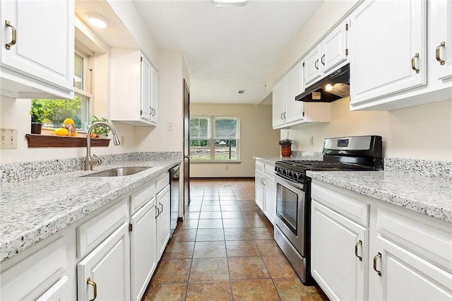 kitchen with white cabinetry, appliances with stainless steel finishes, sink, and tile patterned flooring