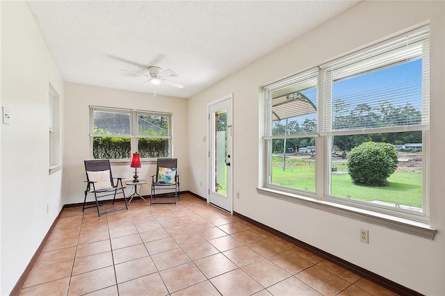 interior space featuring light tile patterned floors and ceiling fan