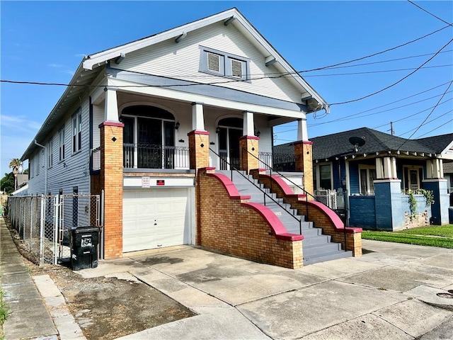 view of front of property with a porch and a garage