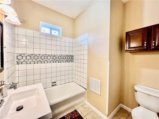 full bathroom with sink, tile patterned flooring, toilet, and tiled shower / bath