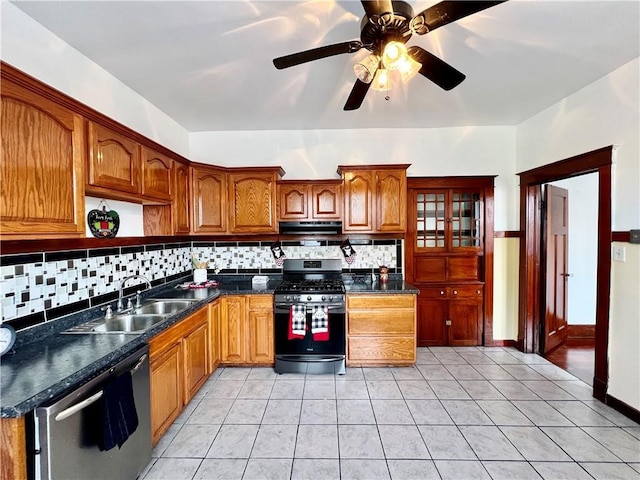 kitchen with sink, appliances with stainless steel finishes, decorative backsplash, and light tile patterned floors