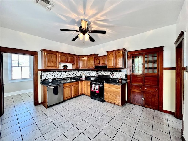 kitchen featuring gas stove, sink, backsplash, stainless steel dishwasher, and light tile patterned flooring