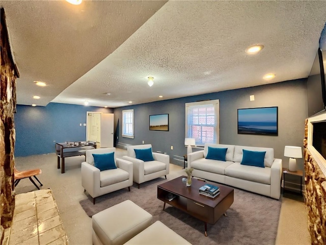 carpeted living room featuring a textured ceiling