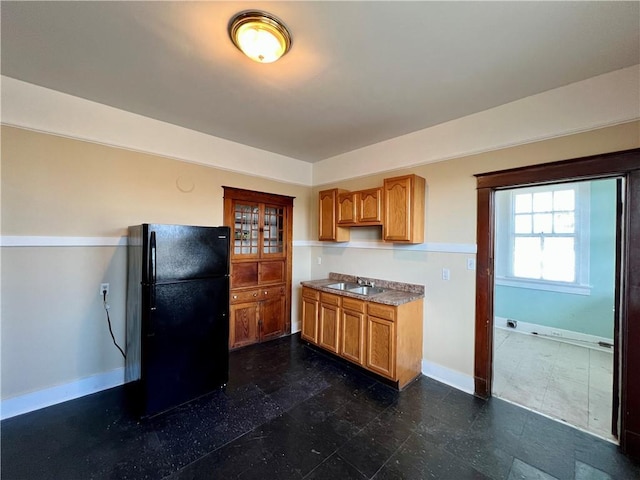 kitchen featuring sink and black refrigerator