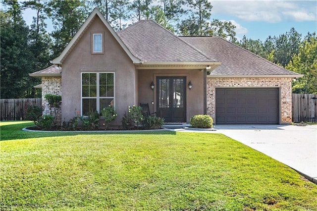 view of front of house featuring a garage, a front lawn, and french doors