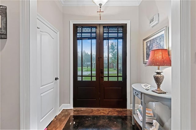 foyer featuring french doors and crown molding