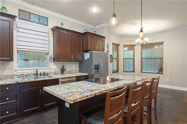 kitchen with sink, hanging light fixtures, a center island, dark brown cabinetry, and stainless steel appliances