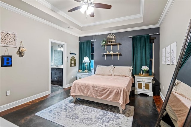 bedroom featuring sink, ensuite bath, ornamental molding, a tray ceiling, and ceiling fan