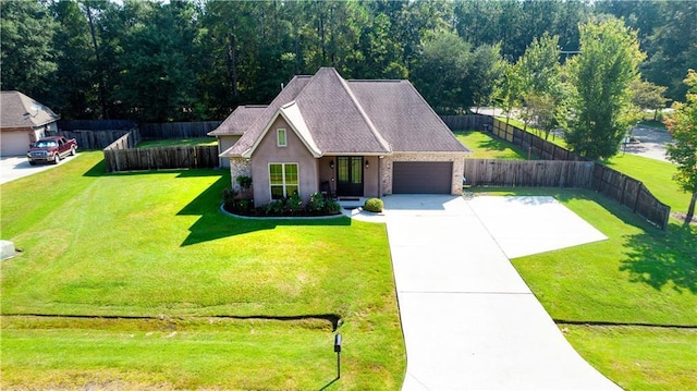 view of front of home with a garage and a front lawn