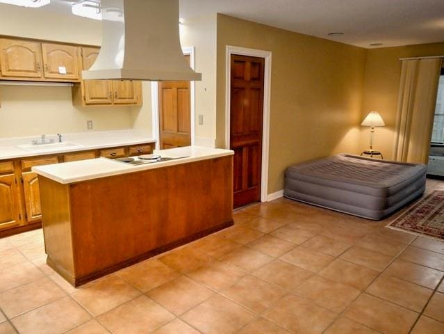 kitchen with extractor fan, black electric stovetop, sink, and light tile patterned flooring