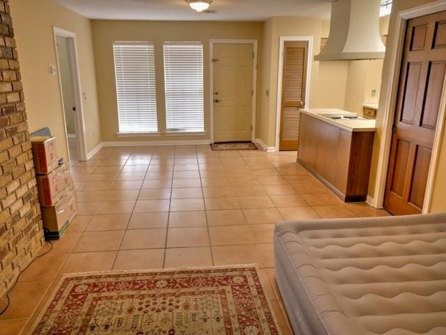 interior space with light tile patterned flooring and a healthy amount of sunlight