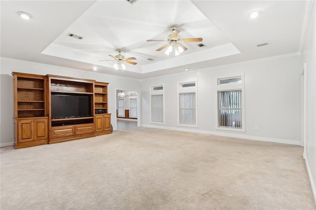 unfurnished living room with ceiling fan, crown molding, light carpet, and a tray ceiling