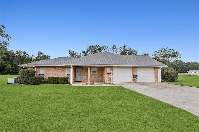 single story home with a garage and a front lawn